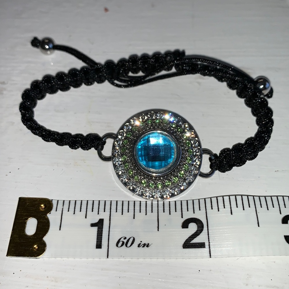 Adjustable braided black cord bracelet with one interchangeable snaps.NWOT